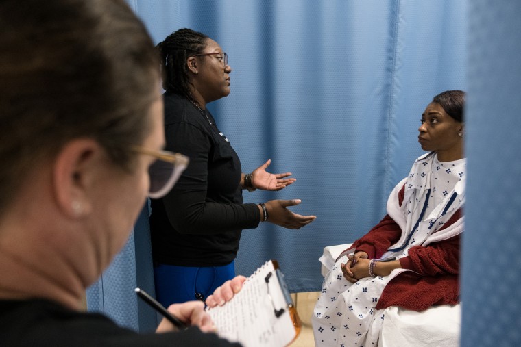 Beth Andrews-Acre, left, and Sharita Godwin, center, roleplay through an examination with Denishia Harris during Sexual Assault Nurse Examiner training