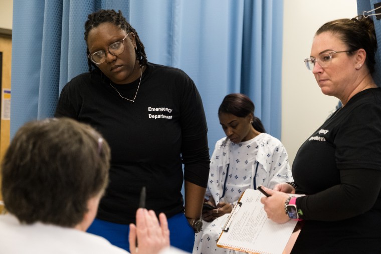 Students receive instructions through an examination during a role play exercise with Denishia Harris, center, during Sexual Assault Nurse Examiner training at Fayetteville State University