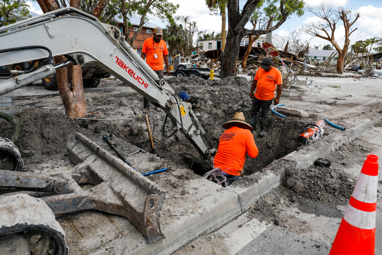 Construction workers try restore services in Fort Myers Beach, Fla, on Nov. 2, 2022, after Hurricane Ian devastated the area in September. Southwest Florida is starting to get back on its feet - and the workers doing the hard labor are largely undocumented migrants.