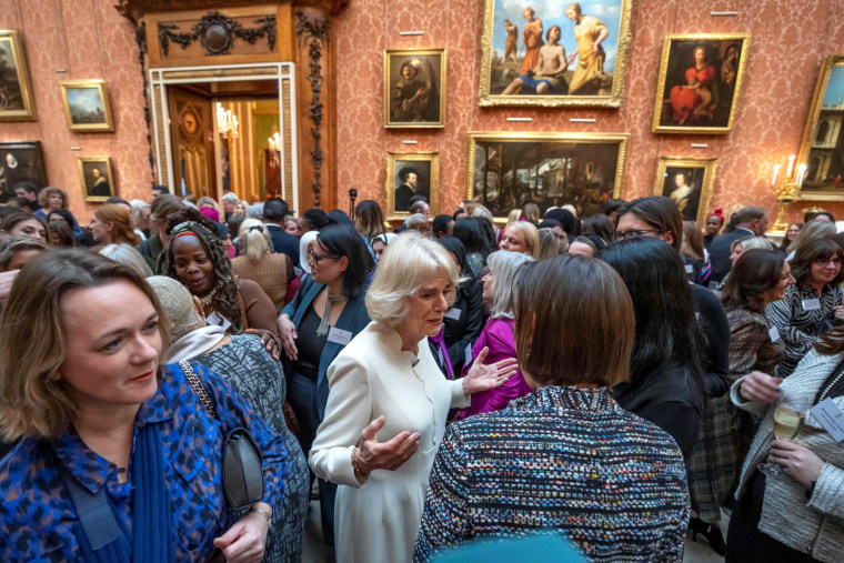 Britain's Queen Consort Camilla, center, speaks to guests near Ngozi Fulani, left, during a reception at Buckingham Palace 