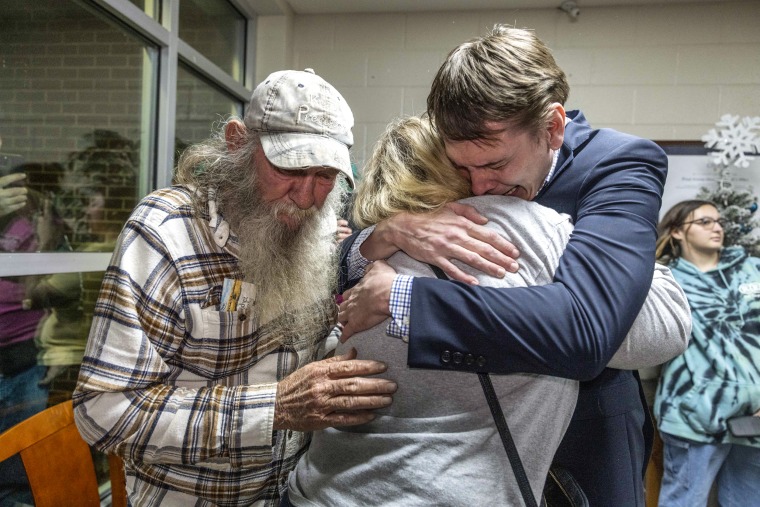 Cain Joshua Storey hugs his family after his release.