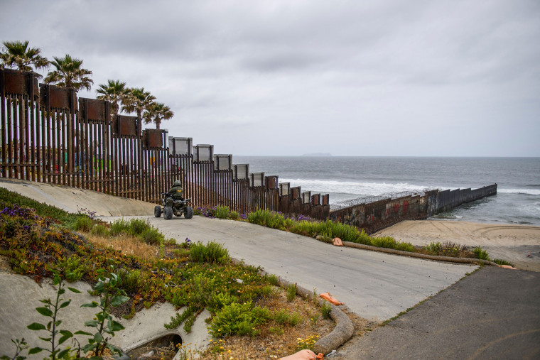 A U.S. Border Patrol agent drives an all-terrain vehicle as the border wall ends in the Pacific Ocean along the U.S.-Mexico border between San Diego and Tijuana, on May 10, 2021 at International Friendship Park in San Diego County, Calif.