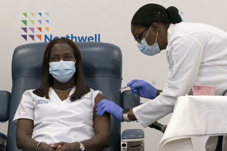 Sandra Lindsay is inoculated with the Pfizer-BioNTech COVID-19 vaccine by Dr. Michelle Chester, at Long Island Jewish Medical Center in Queens, N.Y., on Dec. 14, 2020.