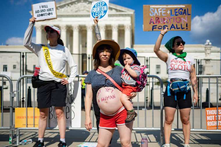 Abortion rights demonstrator Amanda Herring and her one-year-old son Abraham Herring join in protests outside the United States Supreme Court in Washington