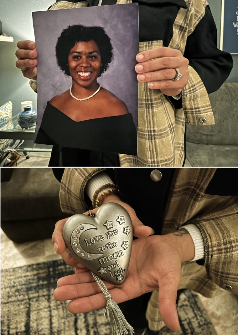 JaQuatta Manahan holds her daughter's senior portrait and a silver heart that she bought to encourage Autumn when she was in the hospital.