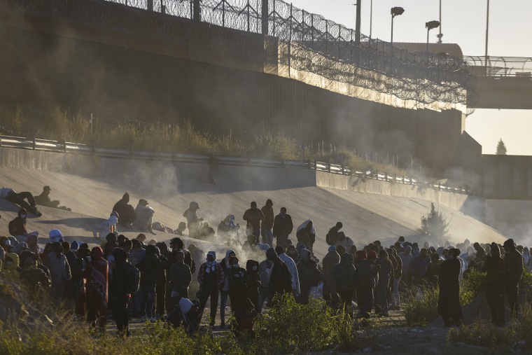 Smoke rises from small fires keeping migrants warm as they wait to cross the Mexico-U.S. border from Ciudad Juarez, Mexico on Dec. 12, 2022. 