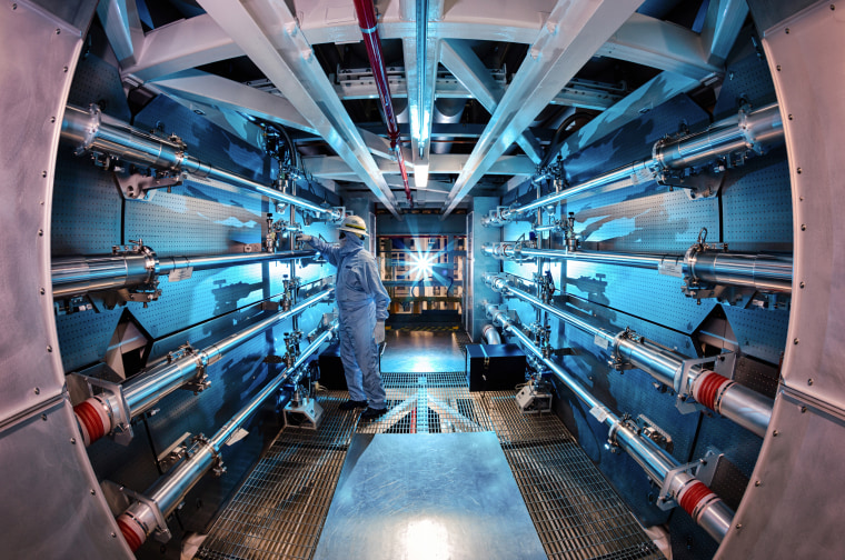 A technician reviews an optic inside the preamplifier support structure at the Lawrence Livermore National Laboratory in Livermore, Calif.