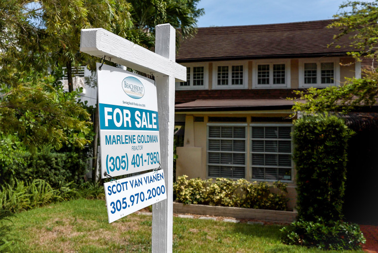 A 'for sale' sign hangs in front of a home on June 21, 2022 in Miami.
