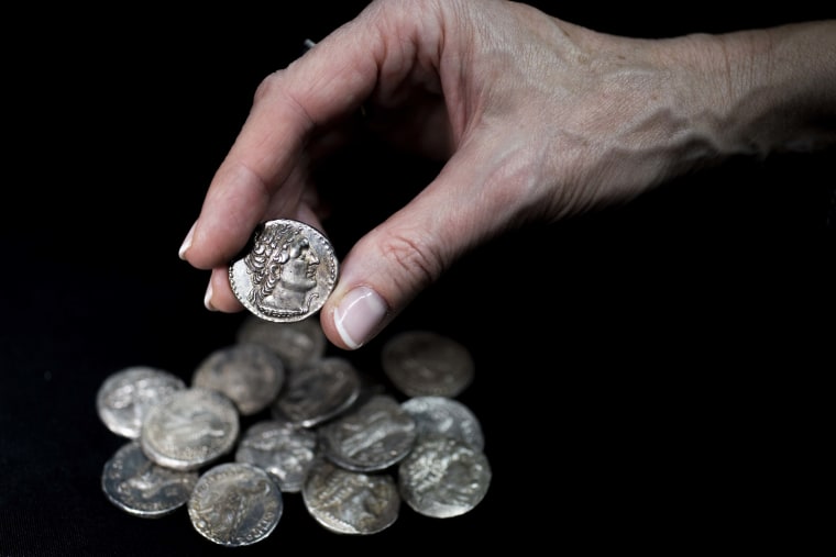 Coins unearthed from the Murba'at cave in Israel are presented after cleaning. 