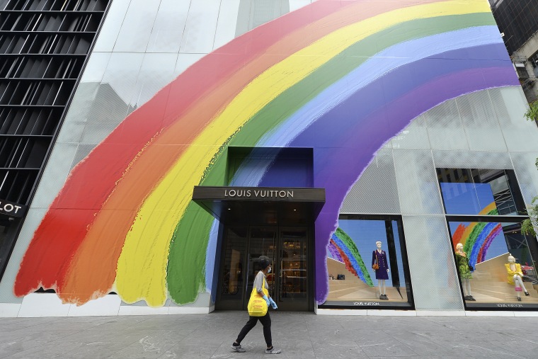 A woman walks past the Louis Vuitton flagship store, decorated for "Pride Month," in New York in 2020. 