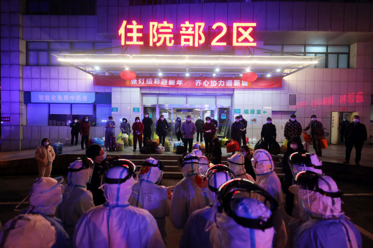 Medical workers prepare to transfer Covid-19 patients in Wuhan in central China's Hubei province on March 3, 2020. 