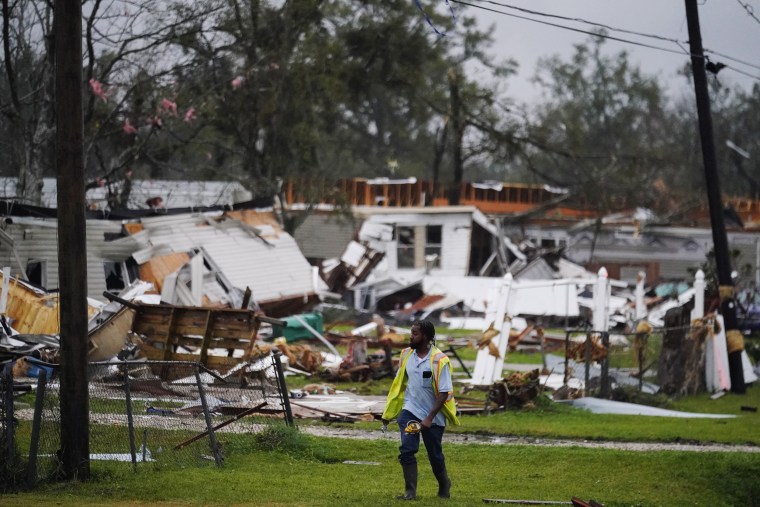 An Atmos Energy employee checks on gas lines after a tornado tore through the area in Killona, La., about 30 miles west of New Orleans in St. James Parish, on Dec. 14, 2022. 