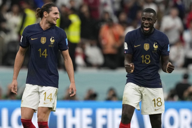 France's Adrien Rabiot, left, and France's Dayot Upamecano celebrate after the World Cup quarterfinal soccer match between England and France, in Al Khor, Qatar, on Dec. 11, 2022. 