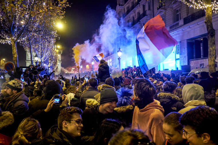 Fans celebrate after France's victory over Morocco in the Qatar 2022 World Cup semi-final, on the Champs-Elysees in Paris on Dec. 14, 2022.