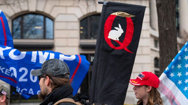Image: A QAnon sign is seen as President Donald Trump supporters hold a rally in Washington.
