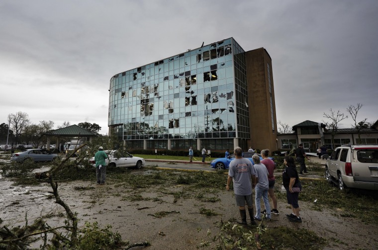 People survey damage following a tornado at the Iberia Medical Center, on Dec. 14, 2022, in New Iberia, La. 