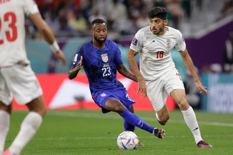 Kellyn Acosta, left, and Mehdi Torabi during the World Cup match between Iran and the United States in Doha, Qatar