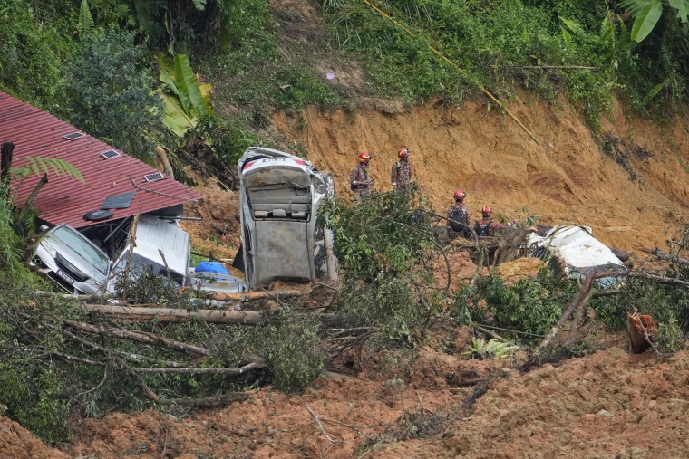 Rescue teams continue the search Saturday, Dec. 17, 2022, for victims caught in a landslide in Batang Kali, Malaysia.