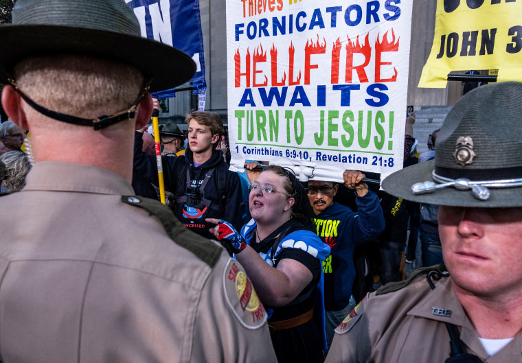 Tennessee State Police stand between Christian nationalists and counter-protestors during a rally against gender-affirming care in Nashville, Tenn., on Oct. 21, 2022.