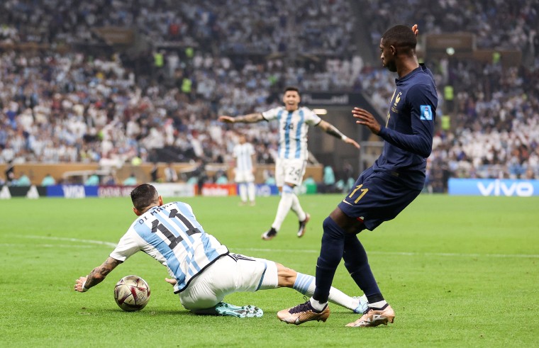 Angel Di Maria of Argentina is fouled by Ousmane Dembele of France, which leads to a penalty kick for Argentina during the World Cup final on Dec. 18, 2022, in Lusail City, Qatar.