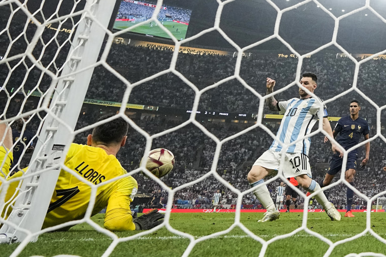 Argentina's Lionel Messi, right, scores his side's third goal during the World Cup final soccer match between Argentina and France in Lusail, Qatar, on Dec. 18, 2022.