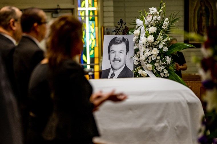 Family members pray during the funeral service for Ernest Robles, 91, founder of the National Hispanic Scholarship Fund, at Holy Name of Jesus Church on Sept. 26, 2022 in Redlands, Calif.