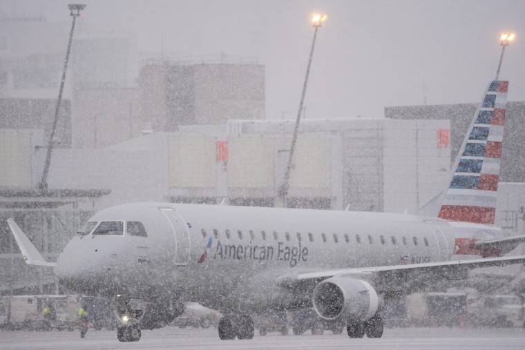 An American Eagle plane taxis during a snow storm at Seattle-Tacoma International Airport (SEA) in Seattle on Tuesday, Dec. 20, 2022. 
