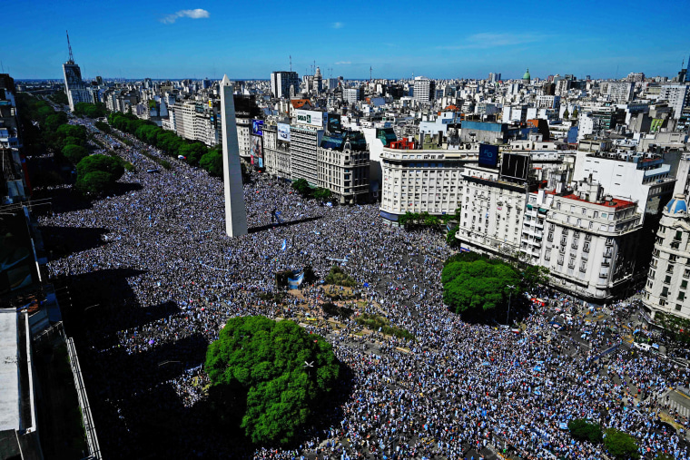 Fans wait for the bus with Argentina's players to pass through the Obelisk in Buenos Aires on Dec. 20, 2022.
