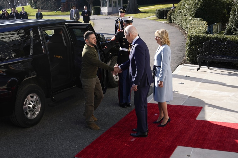 President Joe Biden shakes hands with Ukrainian President Volodymyr Zelenskyy as he welcomes him to the White House, Wednesday, Dec. 21, 2022, in Washington. First lady Jill Biden is at right.