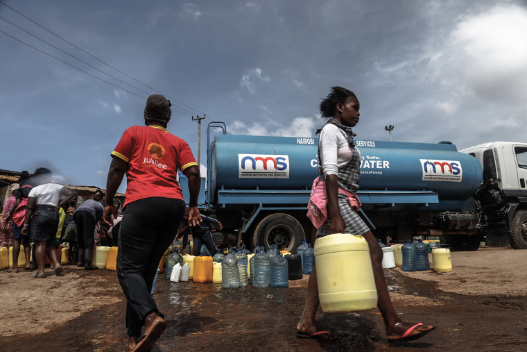 A woman seen carrying her water container filled with water