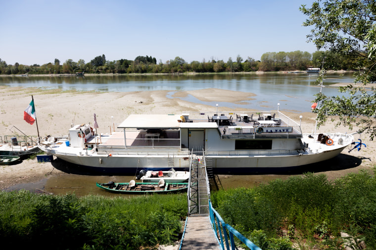 A boat moored on dry waters on the river Po in Ficarolo, Italy, on July 30, 2022. 