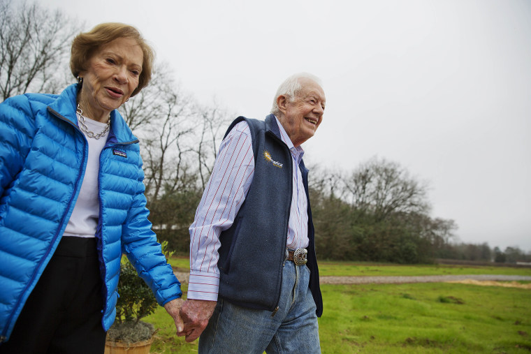 FILE - In this Feb. 8, 2017, file photo former President Jimmy Carter, right, and his wife Rosalynn arrive for a ribbon cutting ceremony for a solar panel project on farmland he owns in their hometown of Plains, Ga. Jimmy Carter and his wife Rosalynn celebrate their 75th anniversary this week on Thursday, July 7, 2021. (AP Photo/David Goldman, File)