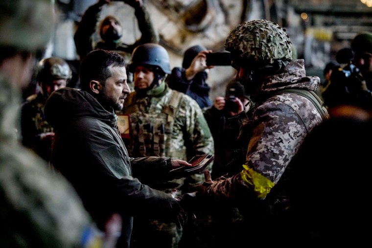 Ukrainian President Volodymyr Zelenskyy hands out the State Award to a soldier during a ceremony in Bakhmut on Dec. 20, 2022.