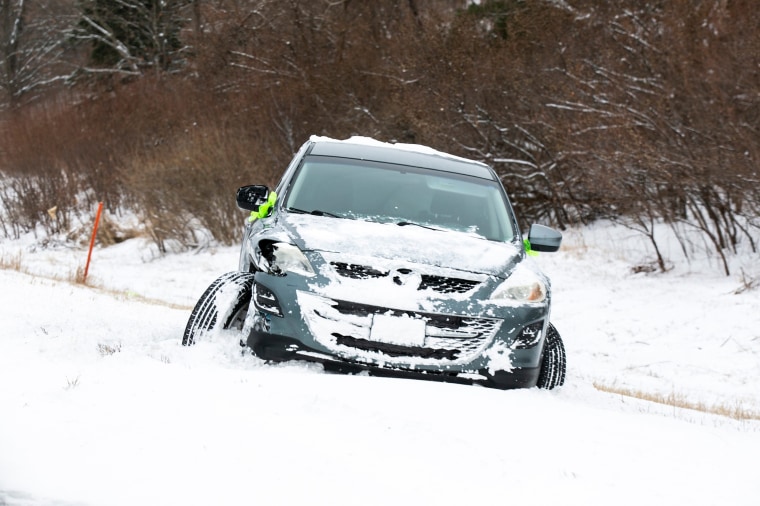 A crashed car is seen in the ditch on Interstate 80 as snow falls during a winter storm warning, Thursday, Dec. 22, 2022, in Iowa City, Iowa. 221222 Snow Storm Ia 003 Jpg