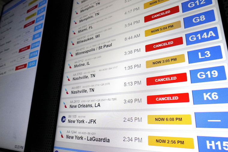 American Airlines flight information screens display flight information, including canceled and delayed flights, at O'Hare International Airport in Chicago, Thursday, Dec. 22, 2022. (AP Photo/Nam Y. Huh)