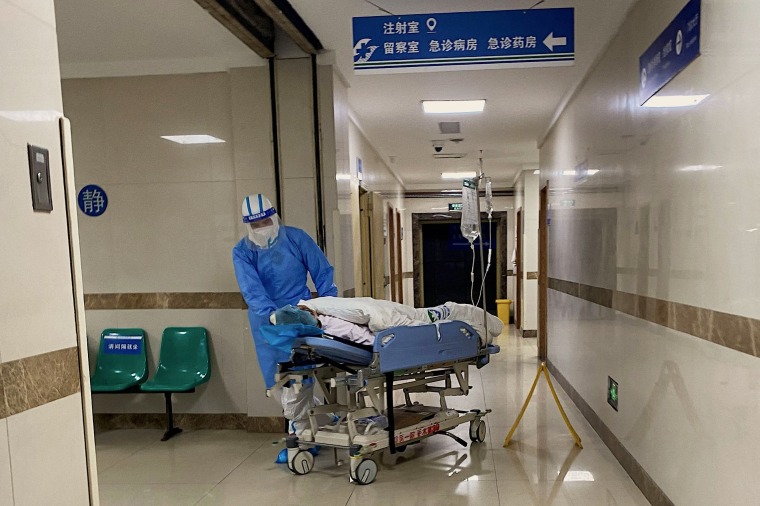 A Covid patient is wheeled on a stretcher at hospital in China's southwestern city of Chongqing on Thursday. 
