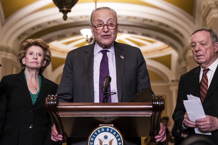 Senate Majority Leader Sen. Chuck Schumer, D-N.Y., speaks alongside Sens. Debbie Stabenow, D-Mich., and Dick Durbin, D-Ill., at the Capitol on Dec. 13, 2022.