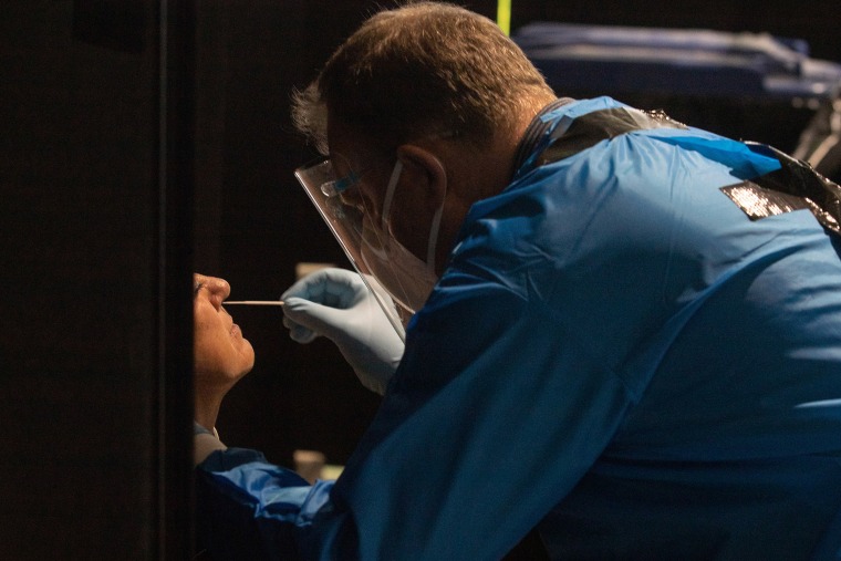 A health worker administers a Covid-19 test in Amsterdam on Dec. 2, 2021