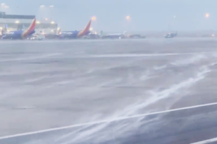 Snow appears to blow across the runway at Denver International Airport on Wednesday. 