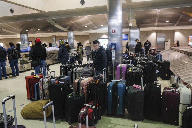 Holiday travelers crowd the Detroit Metro Airport on Christmas Eve following Winter Storm Elliot on Dec. 24, 2022.