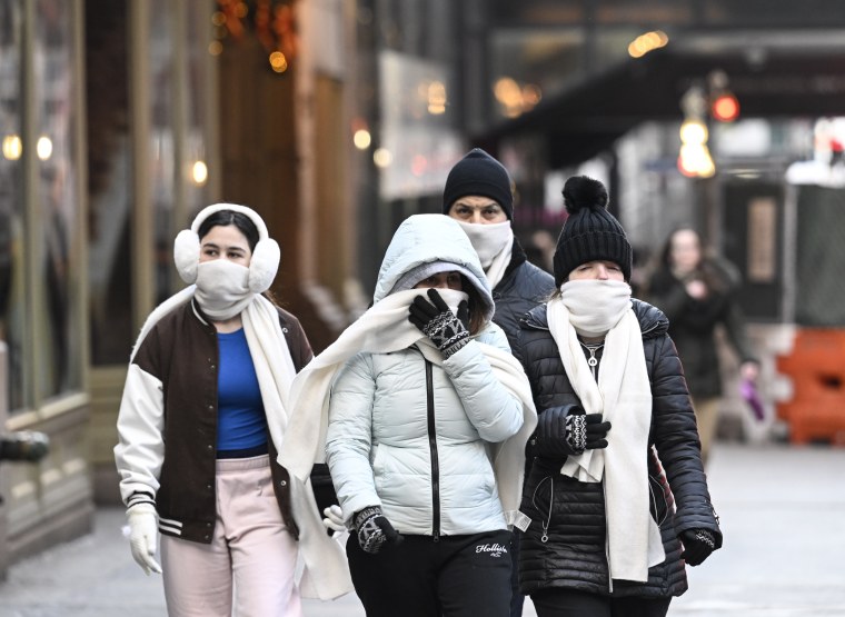 People walk down the street in New York on December 25, 2022.