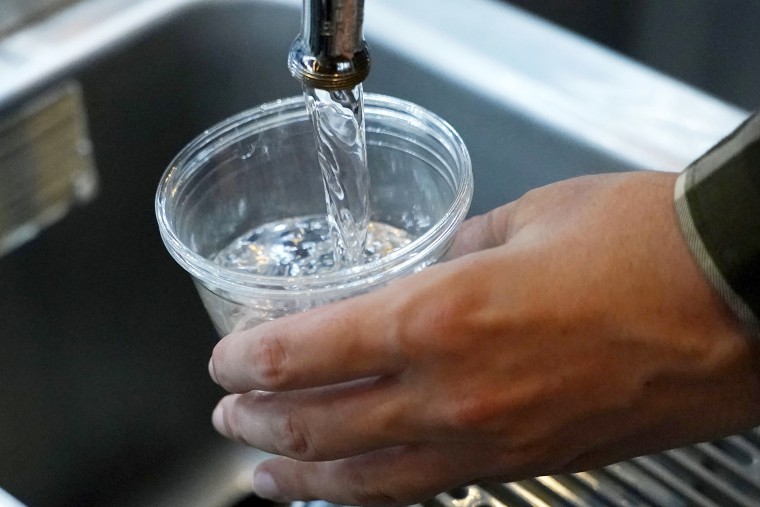 A cup of water is drawn from a faucet at Johnny T's Bistro and Blues, a midtown Jackson, Miss., restaurant and entertainment venue, Thursday, Sept. 1, 2022. Although it is no longer cloudy, owner John Tierre says he has concerns over the city's longstanding water problems. Some business owners report spending anywhere between $300 to $500 per day on ice and bottled water.