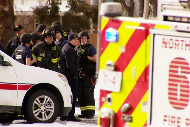 Emergency personnel investigate a murder-suicide at the Jehovah's Witness Kingdom Hall in Thornton, Colo., on Sunday.