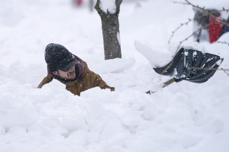 Tommy Retzer excavates his driveway on West Delavan Street in Buffalo, NY on Monday, December 26, 2022.