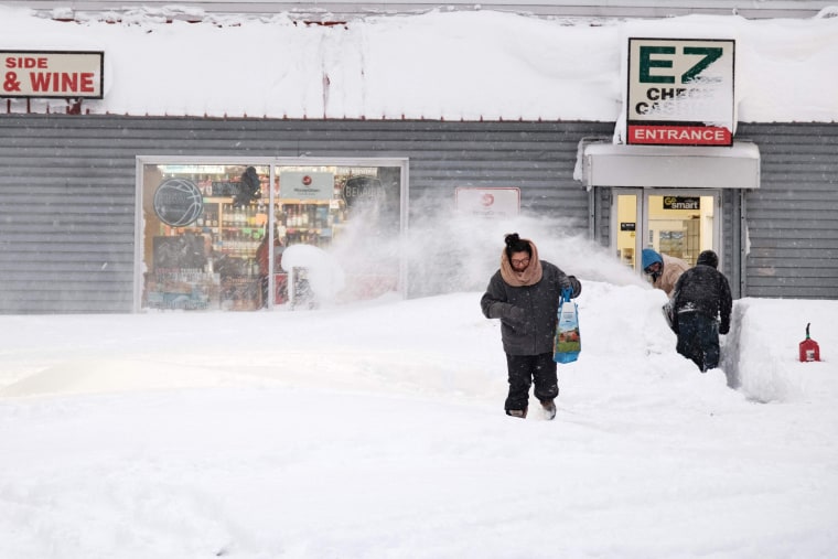 A resident exits a local corner store in Buffalo, New York on Dec. 26, 2022, as many major grocery stores remain closed.  - On Dec. 26, 2022, New York City ambulance crews tried to rescue abandoned residents from what authorities called the "blizzard of the century," a relentless storm that killed at least 25 people in the state and caused chaos during US Christmas trips .  .