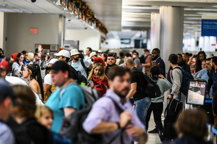 Travelers wait in line at Miami International Airport in Miami, Fla.  on Dec.  23, 2022.