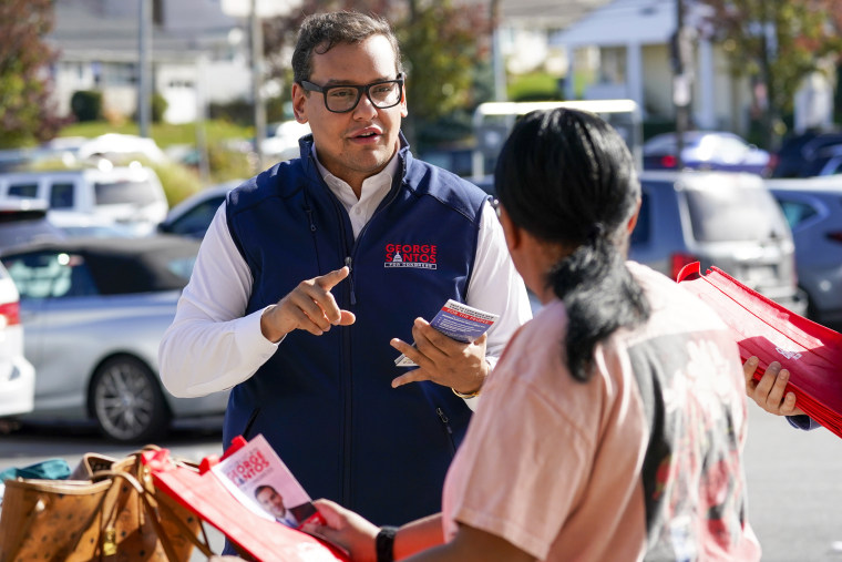 Congressman-elect George Santos talks to a voter while campaigning