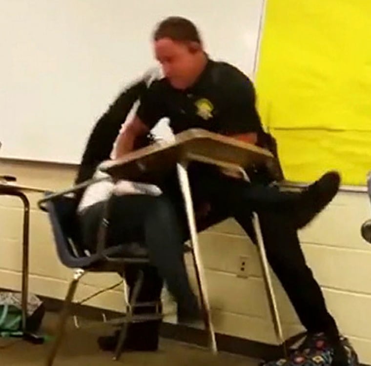 A police officer appears to body-slam a female student at a South Carolina high school in a still image from a cellphone video.