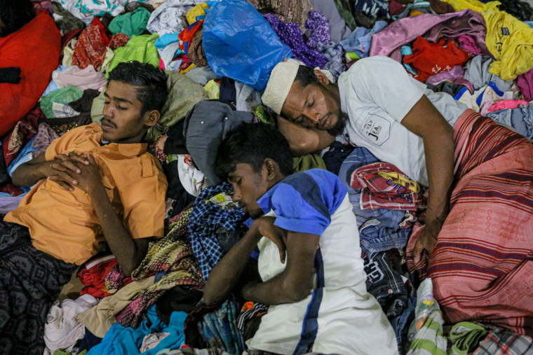 Rohingya men resting at a shelter in the Muara Tiga district on Dec. 26, 2022.