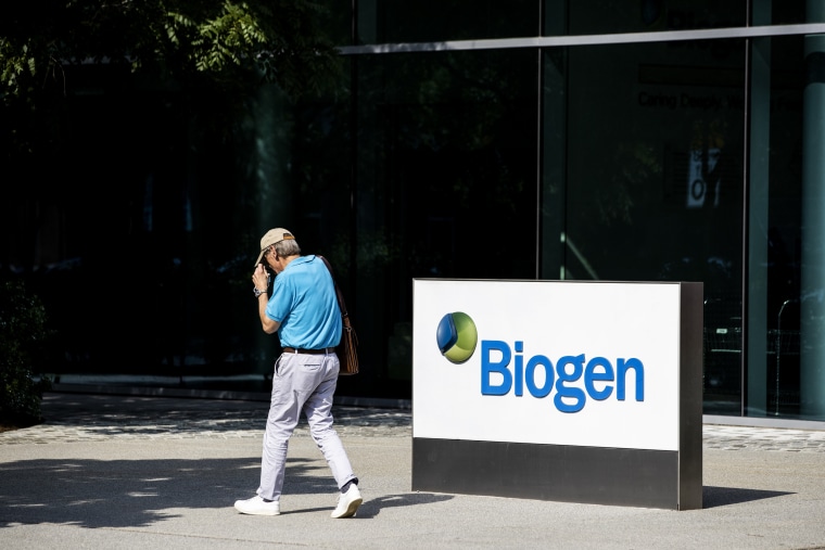 A pedestrian walks past Biogen Inc. headquarters in Cambridge, Mass. on June 7, 2021.